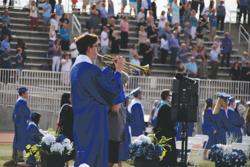 Legend High School senior Hayden Duncan plays the National Anthem on a trumpet during the school’s belated commencement ceremony June 25.