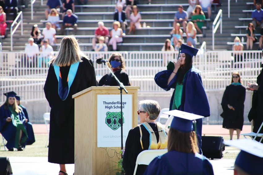 ThunderRidge grads walk across the stage at EchoPark Stadium in Parker June 24, savoring a moment they once thought they’d never get.