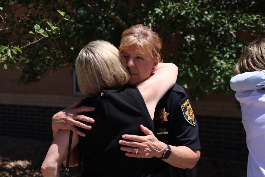 Undersheriff Holly Nicholson-Kluth embraces one of Helene Pruszynski's friends who traveled to Colorado for the sentencing July 1.