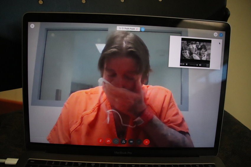 James Curtis Clanton wipes his face as a slideshow of Helene Pruszynski plays during his virtual sentencing July 1.