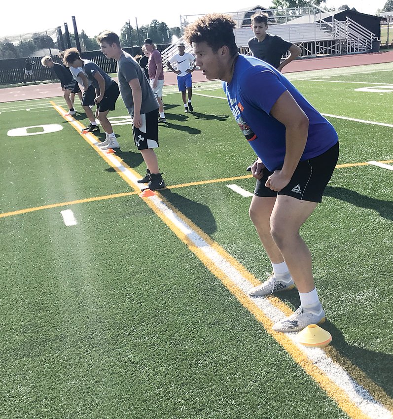 Arapahoe football players line up for an early season workout. There were 150 players that showed up for the workouts as coach Rodney Sherman keeps trying to build the program.