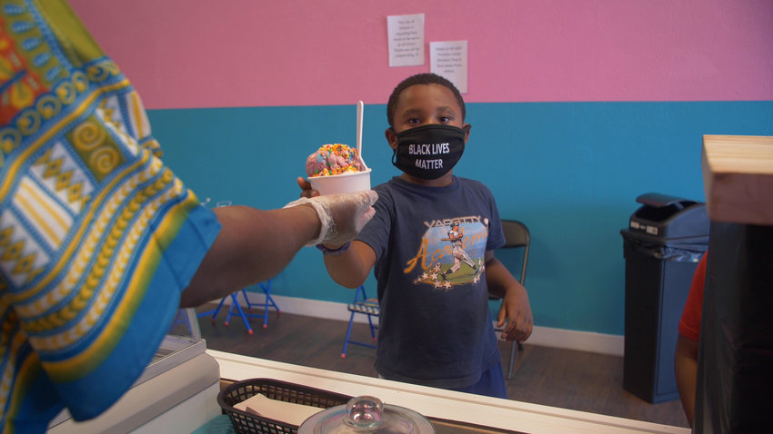 A young customer is served at the new MyKings Ice Cream north of CityPark in Denver.