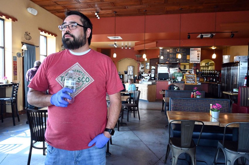 Jesse Arellano stands near the front door of his restaurant, C&C Breakfast & Korean Kitchen, in Castle Rock on Monday, May 11, 2020. Arellano and his wife, April Arellano, opened their restaurant for Mother's Day and had a packed restaurant at times. When the scene went viral, the owners, Jesse and his wife, April Arellano, received both backlash and support.