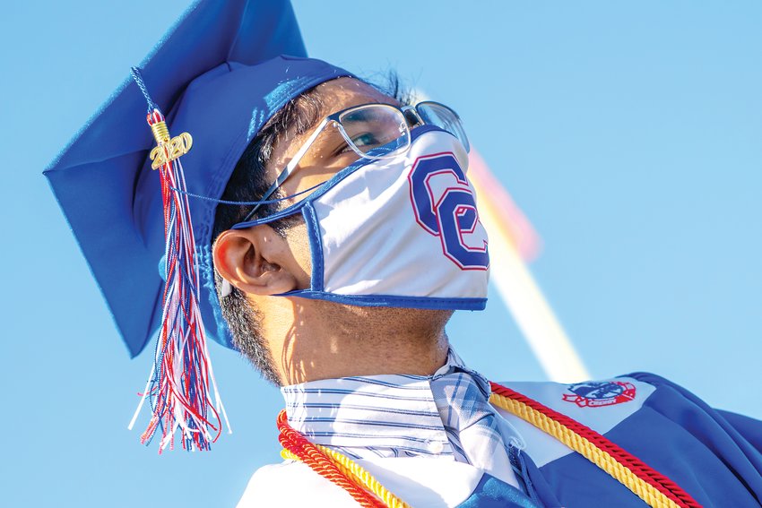 A student wears a mask July 30 at Cherry Creek High School’s graduation. Students and guests were required to wear masks, and many of the graduates’ masks bore their school’s logo.