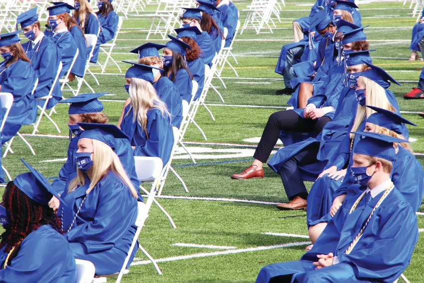 Students at Grandview High School’s graduation ceremony sit in rows spaced apart to comply with social distancing guidelines amid the coronavirus pandemic.