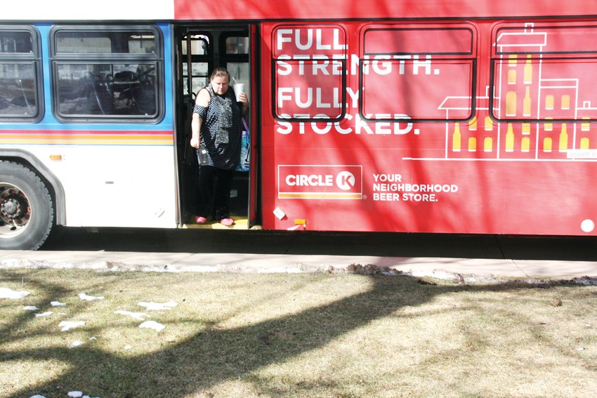 In a February file photo, a woman exits an RTD 16L bus at the 10th and Washington stop in downtown Golden.