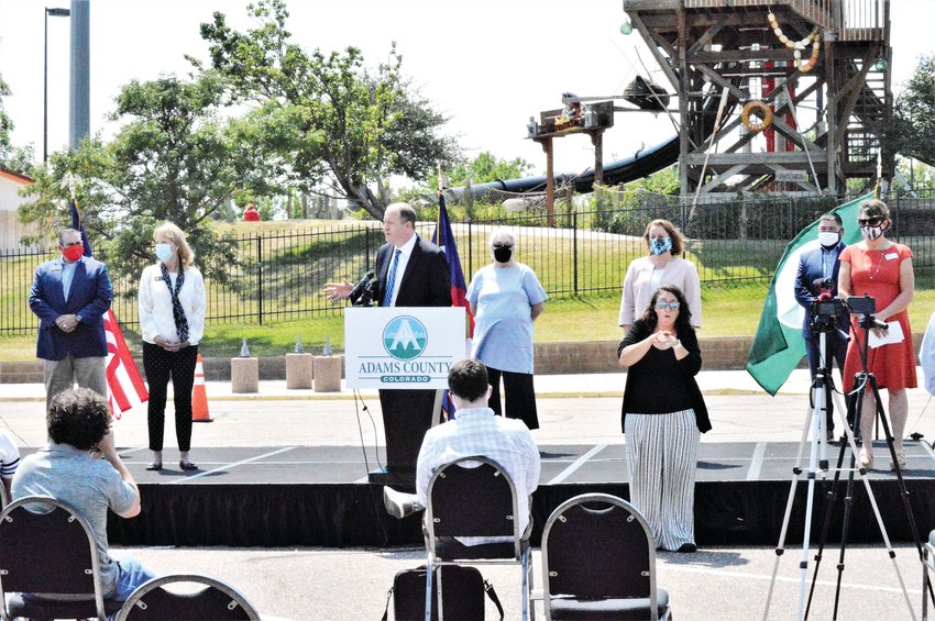 Flanked by Adams County Commissioners and other county officials Aug. 10 in the parking lot of the shuttered Hyland Hills Water World, Governor Jared Polis announced two new free fast-track COVID-19 testing sites.