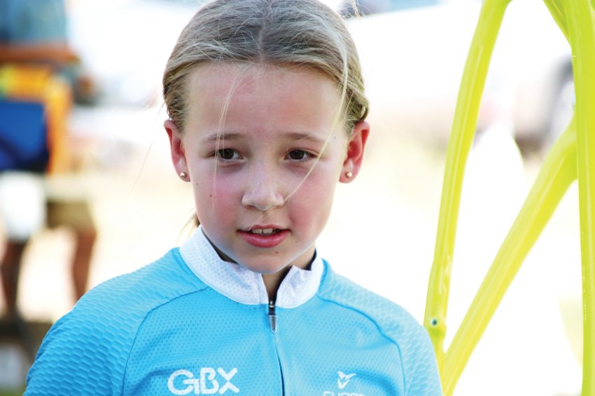 Taya Tousley, 10, stands at her father's tent at the Colorado Junior Cup after placing second in her age bracket earlier that day.