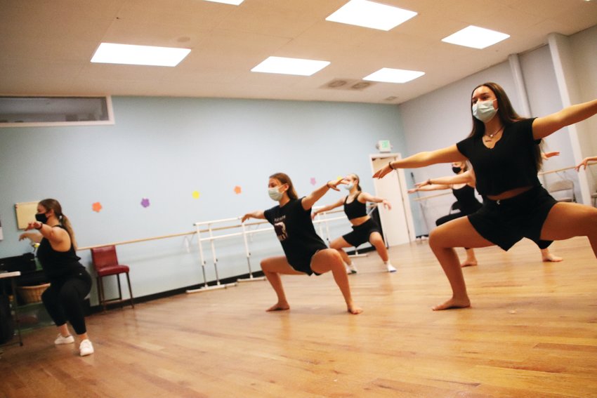 Students at the Parker Dance Academy do plie squats led by Studio Director Lexie Steinhaus. Some students say their strength has improved over the months because they have been forced to relearn some of the basics from home.