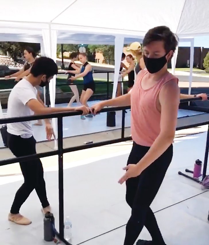 Parker Dance Academy ballet students take a lesson outside the studio on portable barres, socially distanced and with face masks.
