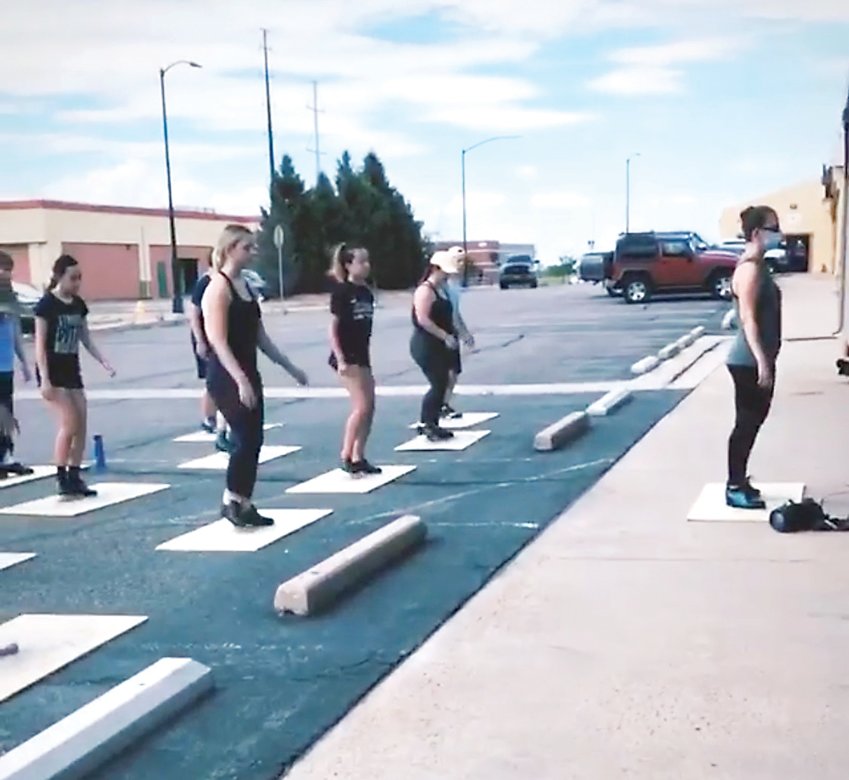 Students at the Parker Dance Academy take part in an outdoor lesson in a parking lot near the studio. Dancers and teachers are adjusting to virtual and socially distanced learning, creating unique obstacles and opportunities.