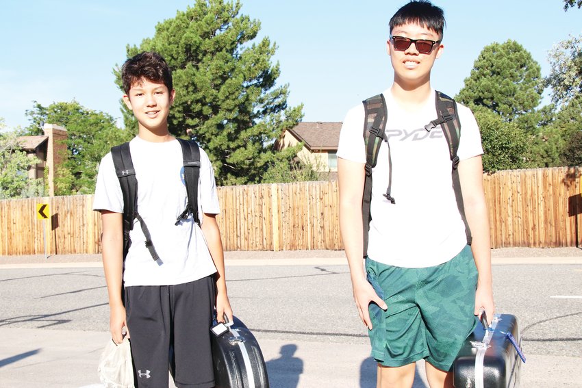 Alex Ford, left, and Isaac Kwon walk to Smoky Hill High School near the Aurora-Centennial border on Aug. 18, their first day of school as freshmen.
