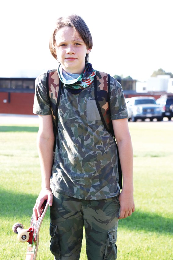 Nathen Ball, a seventh-grader, on his walk to Laredo Middle School. Different grades returned to school on different days the week of Aug. 17, which was organized as a “phase-in week” in which students could come to school to practice new routines, and staff and students could begin to develop relationships, prior to the full start of school.