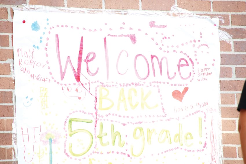 A colorful sign says, “Welcome back 5th grade!” on the wall on the outside Walnut Hills Elementary School Aug. 17 in west Centennial.