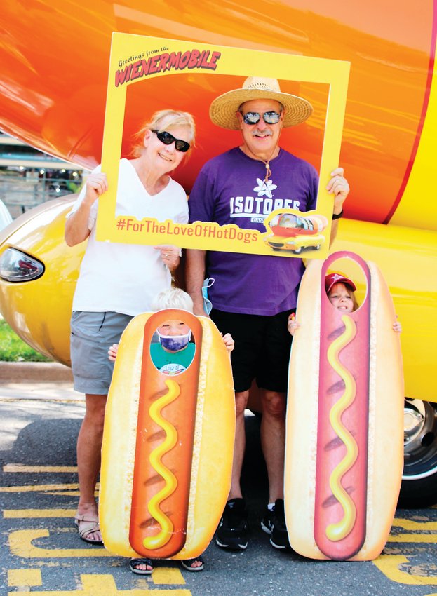Barb and Mike Mulkey of Denver’s West Highlands neighborhood get their picture taken with their grandchildren, Ted, 3, and Grace, 4, in front of the Oscar Mayer Wienermobile at the Denver Zoo on Aug. 19.