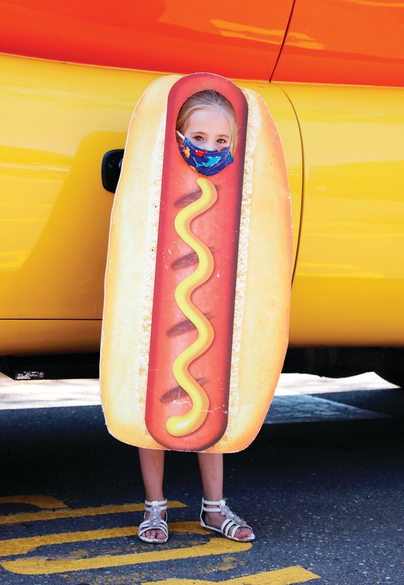Baylie Martin, 7, of Thornton gets her photo taken with a hot dog cutout while visiting the Denver Zoo on Aug. 19. The Denver Zoo was one of the Oscar Mayer Wienermobile’s Colorado stops.