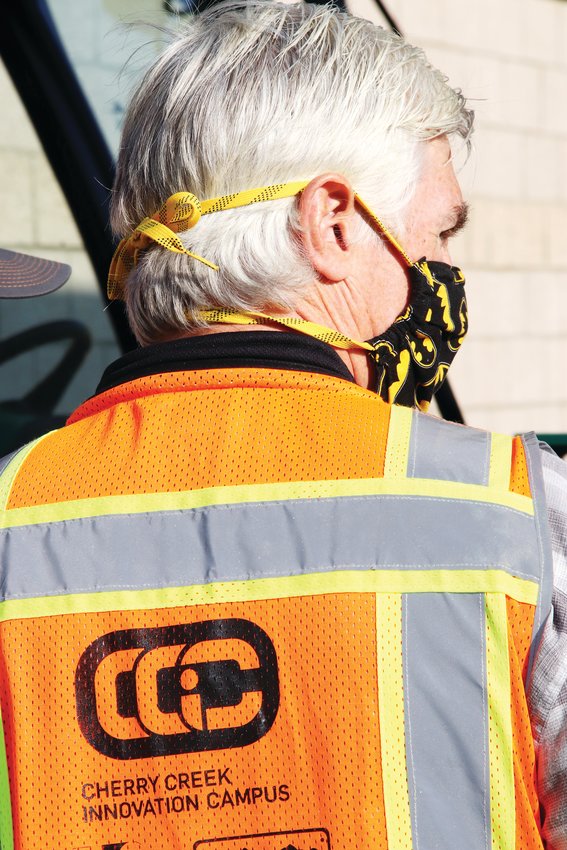 Innovation Campus teacher Don Rauh wears a construction vest bearing the logo of the school, where high school students in the Cherry Creek district come to learn skills in several trades — from construction management to cybersecurity.