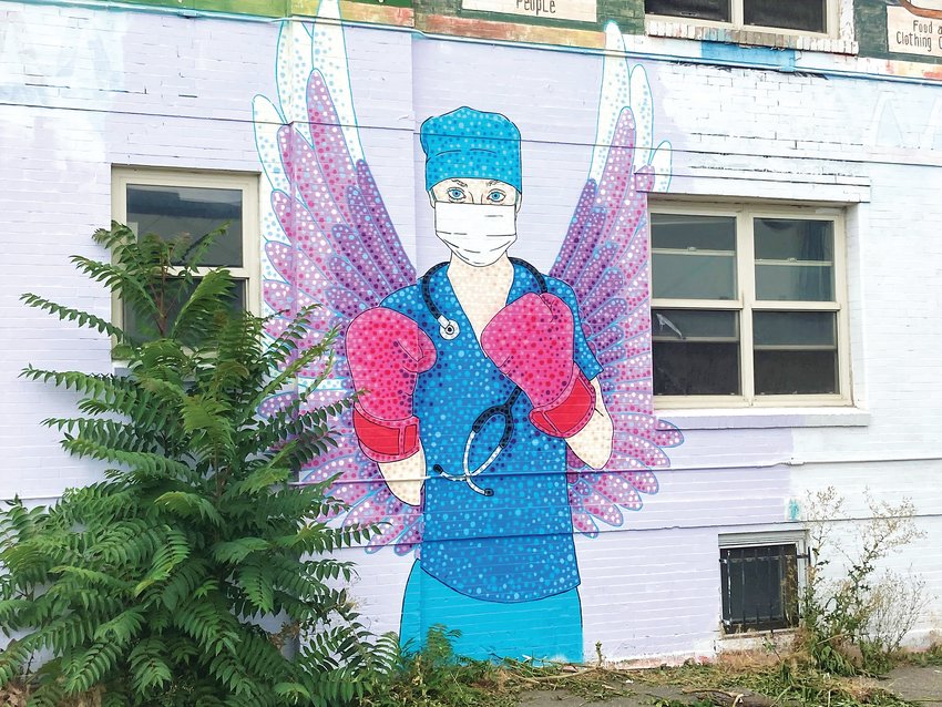 Austin Zucchini-Fowler’s iconic mural of a nurse with boxing gloves on along Colfax Avenue in Capitol Hill.
