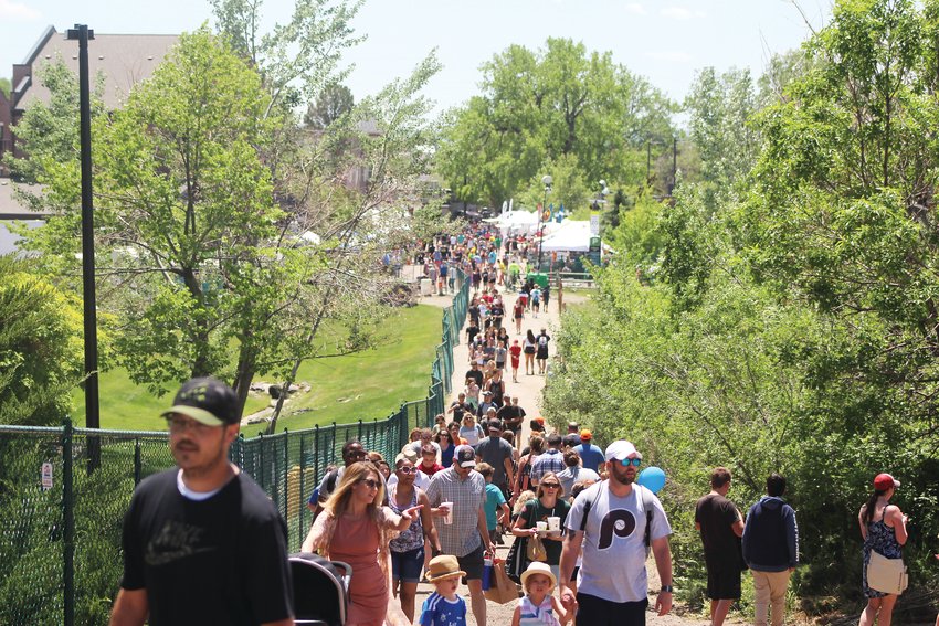 A crowd walks on a trail up to Carnival Hill during the 2019 Parker Days festival.