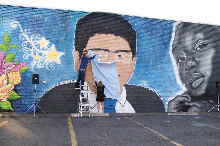 Artists Adam Clark, left, and Ksenia Poteraj unveil their mural of Kendrick Castillo, the 18-year-old STEM School student who was killed in a May 7 shooting at the school.