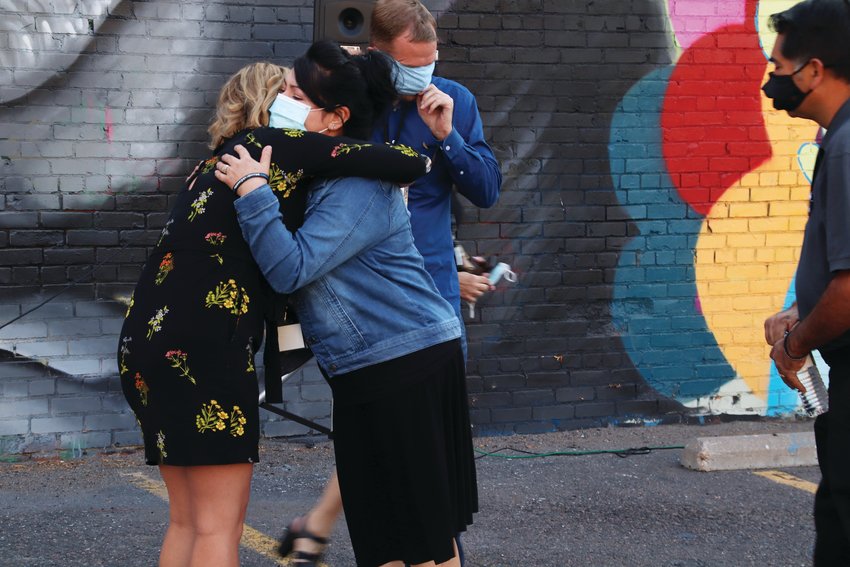 Maria Castillo hugs one of the muralists, Ksenia Poteraj at the unveiling of the mural of her son Kendrick Oct. 4.