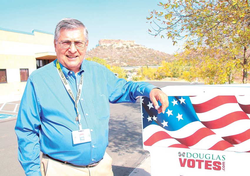 Merlin Klotz, the Douglas County clerk and recorder, poses for a portrait in front of one of the county's ballot drop boxes.