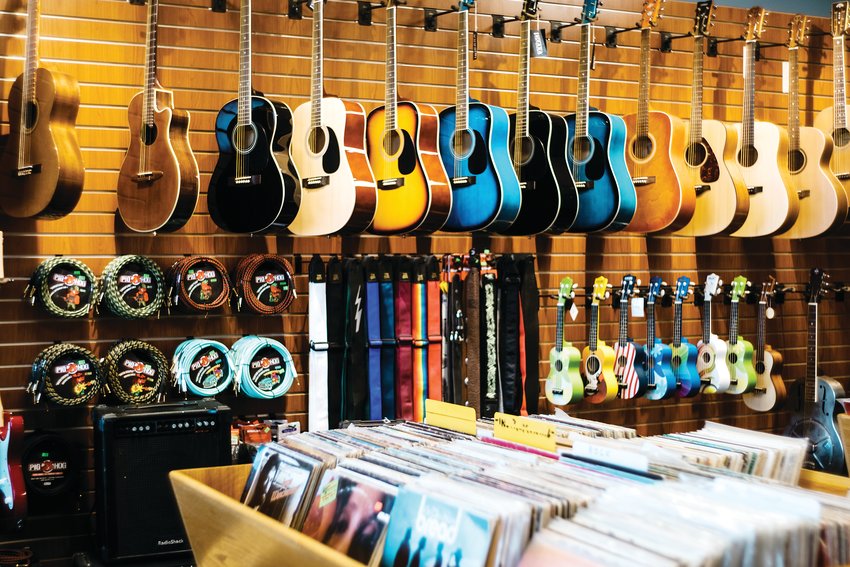 Guitars hang on a wall at Spaceman Guitars.