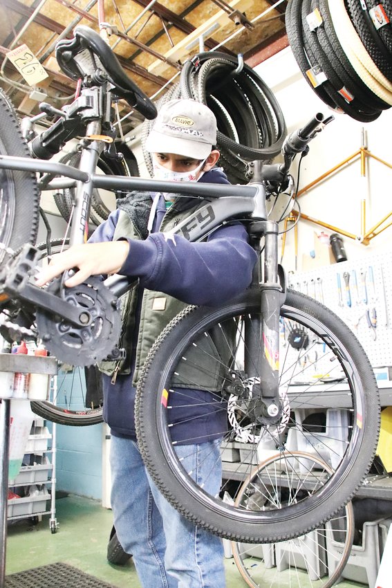 Fernando Ibarra works on a bike at Lucky Bikes Re-Cyclery. Ibarra said working at the shop has given him skills, friendships and life experience.
