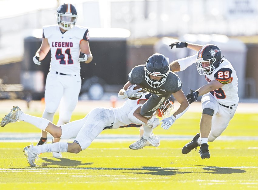 Valor Christian's Gavin Sawchuk (27) gets some air as Legend's Blake Dowd (8) flies in on the tackle. Sawchuk totaled 93 yards in 15 carries, earning a rest for most of the second half.