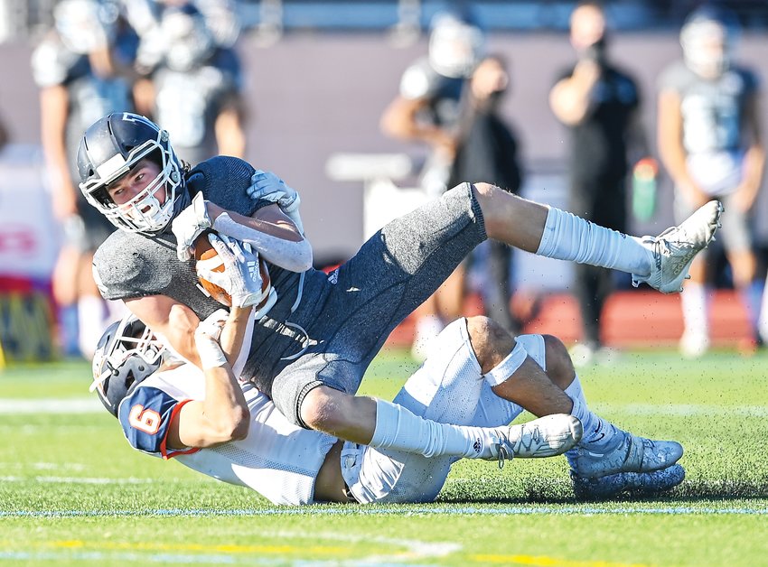 Legend's Jack Bruner (6) pulls Valor Christian's Tyler Larson (6) to the turf in the 5A Semifinal Saturday at Valor Stadium. The Eagles ended the game with a 45-0 victory over the Titans.