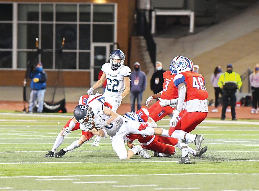 Valor Christian's Tyler Larson (6) gets pulled to the ground by Cherry Creek defenders Sam Pezdirtz (26) and Austin Luhring (16) as teammates Jaxson Hurd (48) and Myles Purchase close in to help.