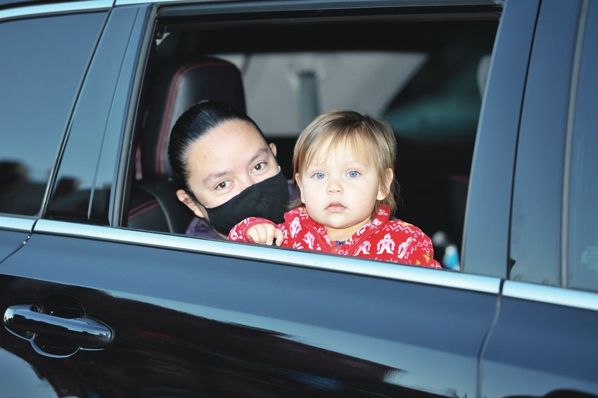 A child and a young adult await Christmas goodies that were handed out during this year’s drive-through Noel Northglenn Dec. 4, at the Northglenn Community Center.