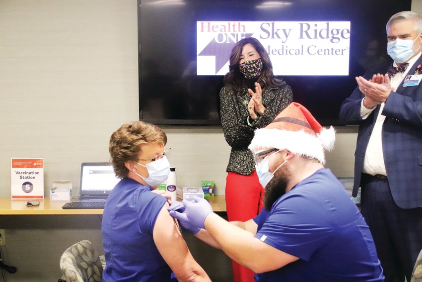 Carol Knight receives the first shot of the Pfizer COVID-19 vaccine Dec. 16 at Sky Ridge Medical Center. Knight, a clinical nurse coordinator, has worked at Sky Ridge for 17 of her 30-year career. "It's time," Knight said. "It's time to start 2021 right."