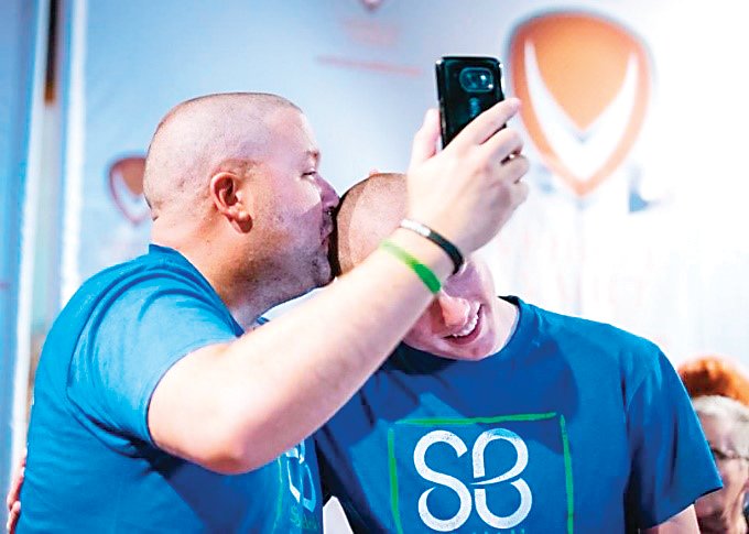 Mike Waid, left, takes part in a St. Baldrick’s Foundation “Shave the Mayor” fundraiser in 2018. Waid poses with his son Matthew, who began shaving his head alongside his dad in solidarity with the charity.