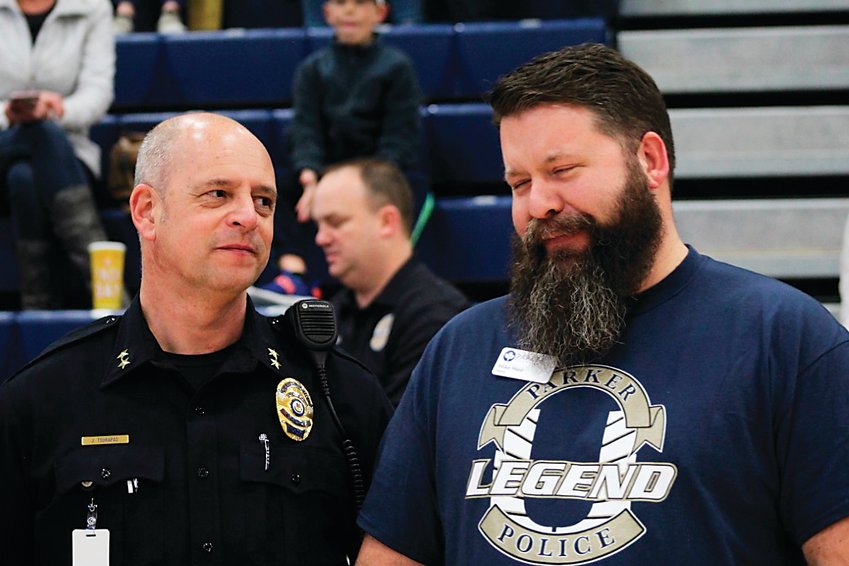 Mike Waid, right, chats with Jim Tsurapas, who was then interim chief of Parker police and is now the department’s chief, during a Unified basketball game in February 2020 at Legend High School.