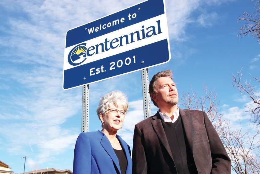 Former Centennial Mayor Cathy Noon, left, and Brian Vogt, one of the city’s founders, stand Feb. 23 near one of Centennial’s farthest-northeast city boundaries, along Reservoir Road near Quincy Avenue. The sign above them reads, “Welcome to Centennial Est. 2001.” The spot is near where Centennial meets Aurora.