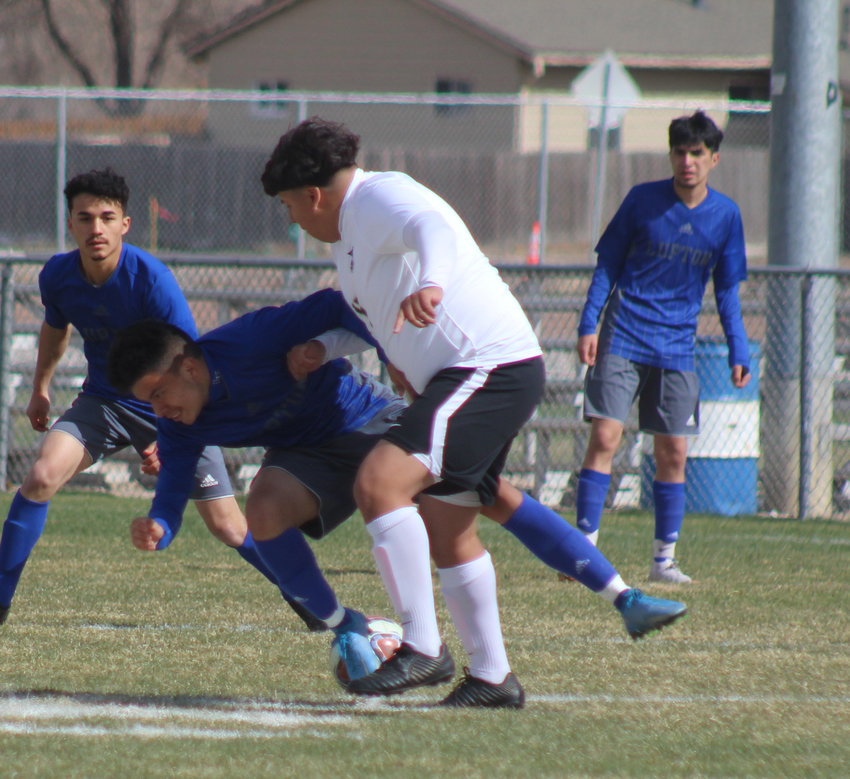 Aurora Central's Nathan Saracay, right, sends Fort Lupton's Jonathan Gonzales to the turf during the first half of the teams' game in Fort Lupton April 17.