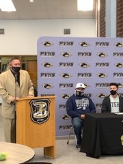 Prairie View baseball coach Mark Gonzales speaks about the athletic accomplishments of Marcus Sanchez, far right, during a letter-of-intent program at the school April 19.