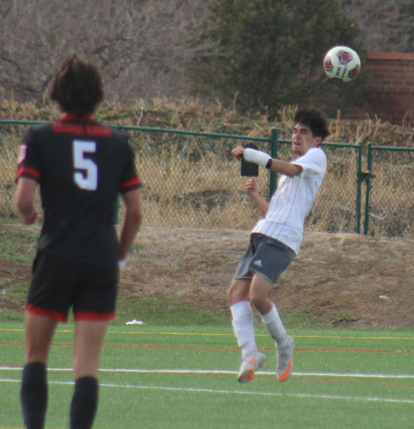 The Bludeevils' Brandon Ruiz heads the ball out of harm's way during the state 3A soccer playoffs April 22 at Colorado Academy. Nico Watters (5) of CA also is in the picture.