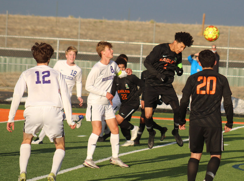 Adams City's Gabriel Ortega heads the ball out of danger during the first round of the state 5A soccer tournament April 22. Boulder's Cameron Gerber (8), Oliver English (18) and Calvin Pielke (12) as well as the Eagles' Mauricio Alipizar (22) and Alejandro Rodriguez (20) are in the picture.