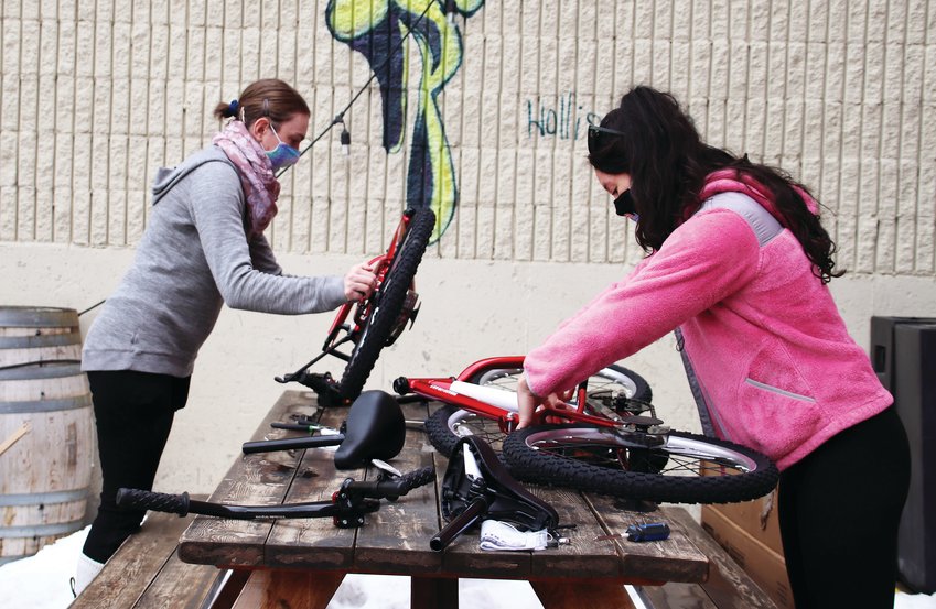 Friends and roommates of northeast Denver, Kelsey Thompson, left, and Autumn Brennan, had been looking into additional volunteer opportunities. Though they had never built bikes before, they saw Can’d Aid’s event on Facebook and thought it sounded like fun.