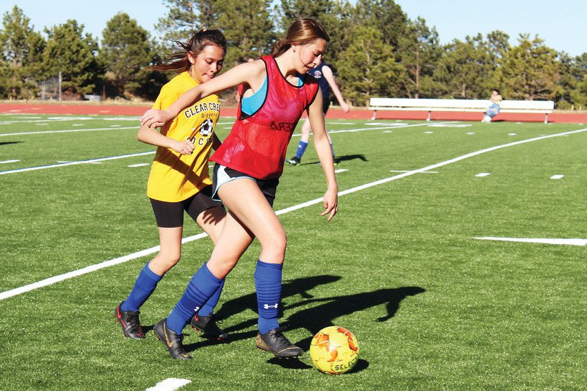 Left: Freshman forward Ailin Salinas, left, fights junior midfielder Aiden Kocol for possession of the ball during Friday’s Clear Creek girls soccer practice.