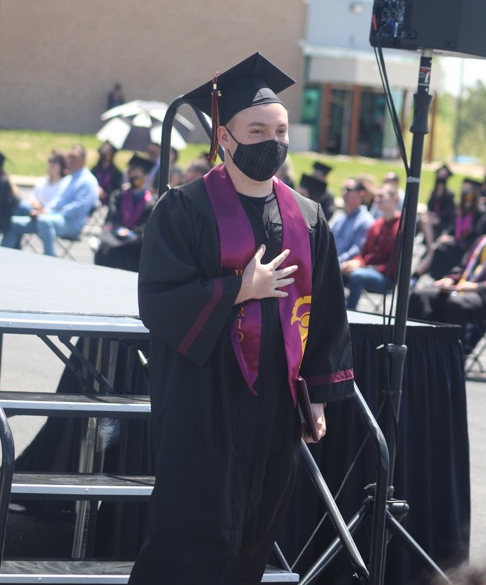 ERA graduate Brennan Owens makes his way through a faculty salute during commencement exercises May 19.