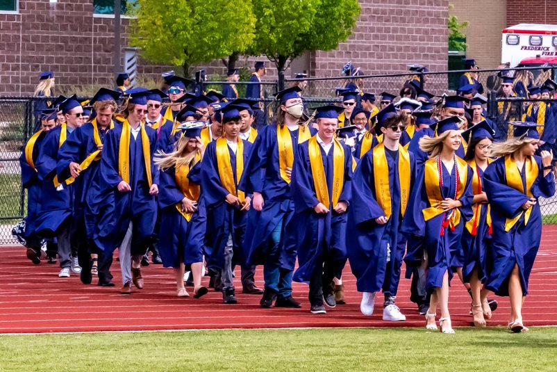 The class of 2021 marches onto the football field at Frederick High School May 29.