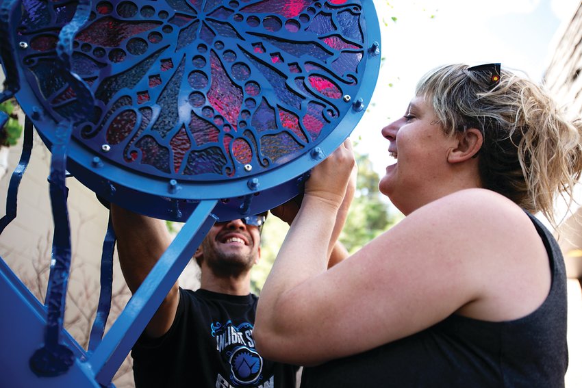 Jodie Bliss and Chris Daddario assemble Bliss’ sculpture titled “Light Hearted Drummer” in downtown Evergreen on June 5. This sculpture was one of 10 installed in Evergreen and Bergen Park.