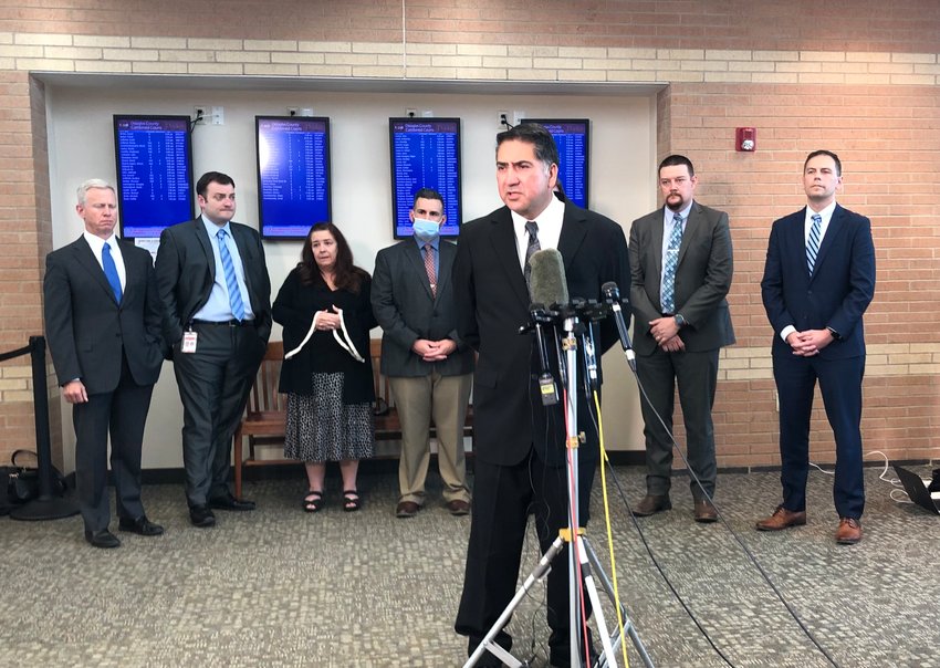 John Castillo speaks with reporters June 15 after a jury found Devon Erickson, the person who fatally shot his son, guilty of first-degree murder. He stood in front of investigators and prosecutors from the district attorney's office.