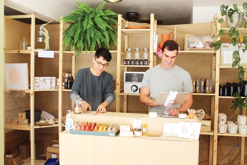 Owners Tyler and Justin Fukae prepare to open their store, Sabel, in the morning on June 17. The Lakewood couple started Sabel in mid-March, and sell everything from dog treats and bamboo utensils to skincare products and coffee.