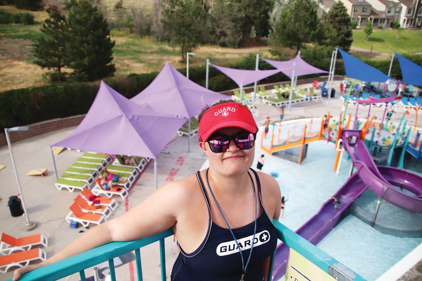 Lifeguard Aubrey Pierce, 18, poses for a portrait while on duty at the top of the slides at H2O'Brien Pool in Parker.