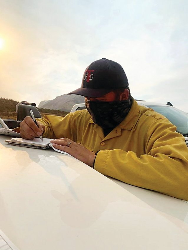 Thornton Firefighter Lieutenant Perry Otero makes notes during his time deployed to Grand Junction to help fight the Pine Gulch Fire.