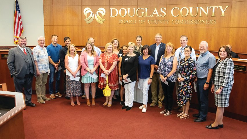 Recipients of the Philip S. Miller grant pose with the Douglas County commissioners after receiving their checks July 13.